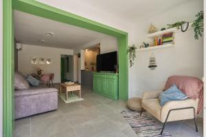 a living room with two couches and a tv at Casita Helena in Torrox