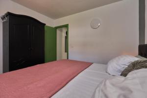 a bedroom with a bed with white sheets and green walls at Casita Helena in Torrox +12 photos