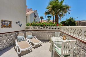 a patio with a table and chairs on a balcony at Casita Helena in Torrox