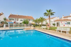 a swimming pool in front of some houses at Casita Helena in Torrox