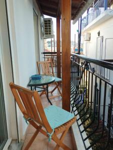 two chairs and a table on a balcony at Alexandras Maisonette in Skiathos