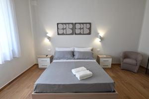 a bedroom with a large bed and a chair at Villa Grazia in Oliveto Citra
