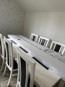 a white table and chairs with a white table at Faruqshus in Mönsterås