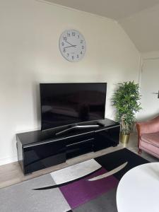a living room with a large clock on the wall at Faruqshus in Mönsterås
