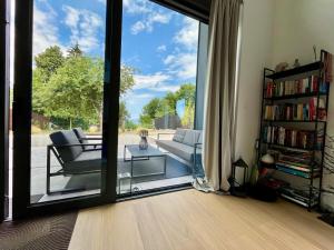 a living room with a large sliding glass door at Casa Verta in Skrad