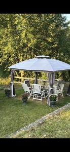 a group of chairs sitting under a large umbrella at Faruqshus in Mönsterås