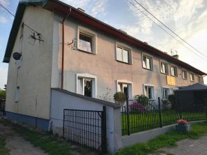 a house with a fence in front of it at Apartament Wiejski Raj in Kozy