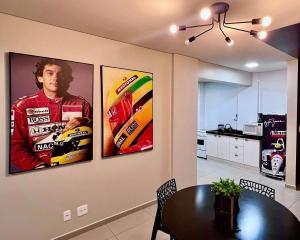 three posters on a wall in a kitchen with a table at Edifício Madrid | Ayrton Senna in Toledo +16 photos