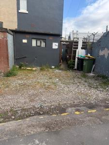 a house with a yard next to a building at New Hawkes Hotel in Blackpool