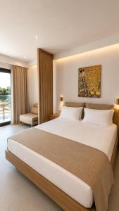 a hotel room with a large bed and a window at Minimal Suites in Skala Rachoniou +16 photos