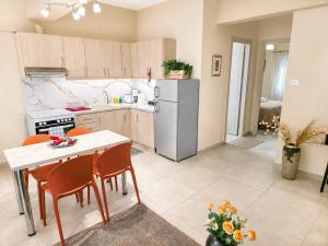 a kitchen with a table and a refrigerator at Elena's nest in Kastoria +18 photos