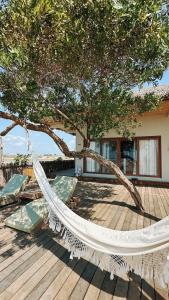 a hammock under a tree on a deck at Kiterise Tatajuba in Tatajuba +26 photos