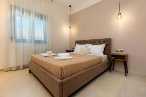 a bedroom with a large bed with two towels on it at Zen Garden Villa in Theológos