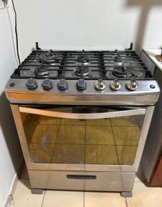 a stove top oven sitting in a kitchen at Exclusive Casa Oro 3VX in San Pedro Sula +21 photos