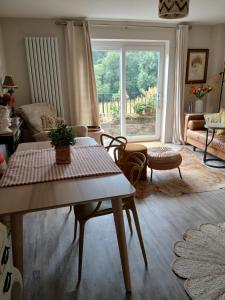 a living room with a table and a large window at Claro Mews Gem in Knaresborough