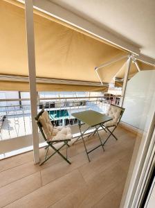 a table and two chairs in a room with a boat at Ventora Suites in Nydri