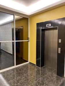 an empty hallway with a elevator in a building at POSH HOTEL iSLAND in Victoria Island