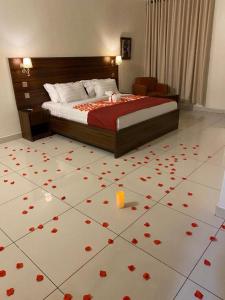 a bedroom with a bed with red flowers on the floor at POSH HOTEL iSLAND in Victoria Island