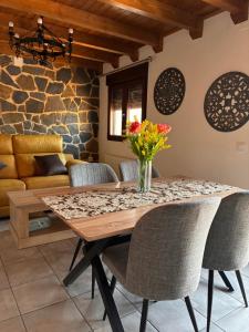 a dining room with a wooden table and chairs at Los Ayales in Huelamos