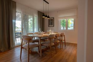 a dining room with a table and chairs at Holiday Home Ari in Lički Ribnik