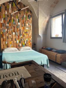 a bedroom with a bed and a wooden wall at SUITES JACUZZI La Stratodda OSTUNI Torre Guaceto in San Vito dei Normanni