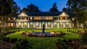 a large house with a statue in the front yard at Hotel Indigo - Winston-Salem Downtown by IHG in Winston-Salem
