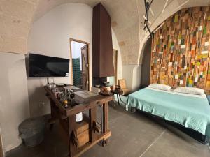 a bedroom with a bed and a table and a mirror at SUITES JACUZZI La Stratodda OSTUNI Torre Guaceto in San Vito dei Normanni