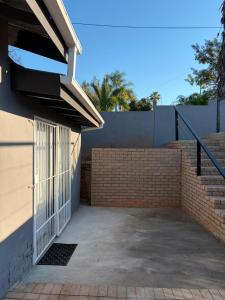 a building with a gate next to a brick wall at Stay at Tzaneen in Tzaneen