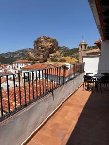 a balcony with tables and chairs on a building at Los Ayales in Huelamos