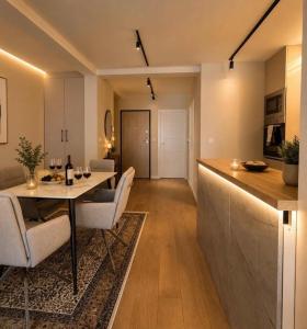 a kitchen and living room with a table and chairs at Vista Visoko Apartants in Visoko