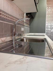 a stainless steel sink in a kitchen at Los Ayales in Huelamos +84 photos