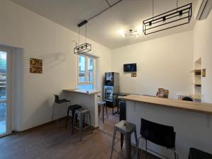 a bar in a room with stools and a counter at Monkey Hostel Milano in Milan