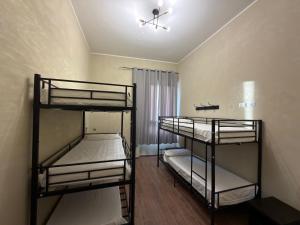 a room with three bunk beds in a room at Monkey Hostel Milano in Milan
