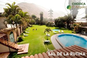 a view of a resort with a pool and palm trees at El Angolo Chosica in Nicolas de Pierola