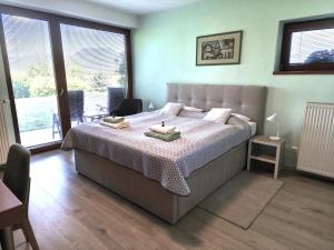 a bedroom with a large bed with two candles on it at Apartmány Kvetná in Rajecké Teplice