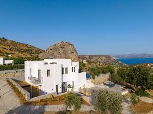 an aerial view of a white house on a cliff at Evgoro Luxury Suites in Agia Galini