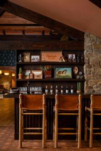 a bar in a restaurant with two chairs at Wayfinder Bishop in Bishop