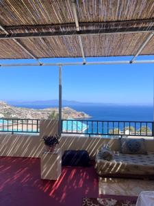 a living room with a couch and a view of the ocean at Belyounech in Belyounech 