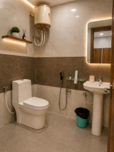 a bathroom with a toilet and a sink at Hotel jetway in Muthugadahalli +60 photos