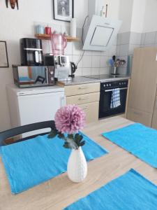 a kitchen with a vase with a flower in it at Ferienwohnung in Flörsheim am Main