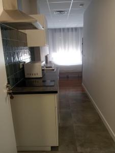 a kitchen with a counter and a window in a room at Morgan Apartments Bilbao in Bilbao