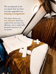a bed with two towels on it in a room at Fjord Panorama Lodge in Strand