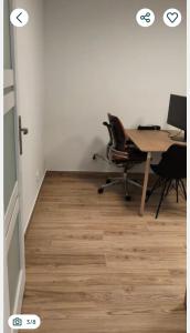 an office with a desk and chairs and a table at Polna 16 in Mrągowo