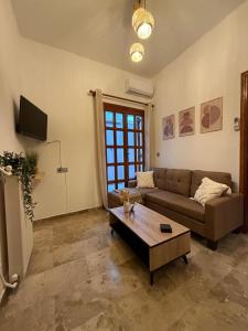 a living room with a couch and a coffee table at Petalidi seaside Retreat in Petalidi