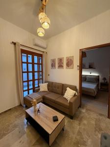 a living room with a couch and a coffee table at Petalidi seaside Retreat in Petalidi