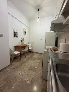 a kitchen with a table and a dining room at Petalidi seaside Retreat in Petalidi