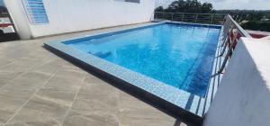 a swimming pool on the side of a house at Tulia Stays in Mtwapa