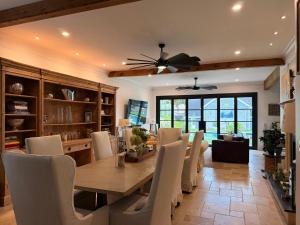 a dining room with a table and white chairs at Midtown 6bed 5bath w pool and sauna in Atlanta