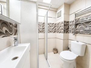 a white bathroom with a toilet and a sink at Askin Suits Canakkale in Çanakkale