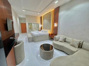 a living room with a couch and a bed at One One B Luxury Hotel in Asaba